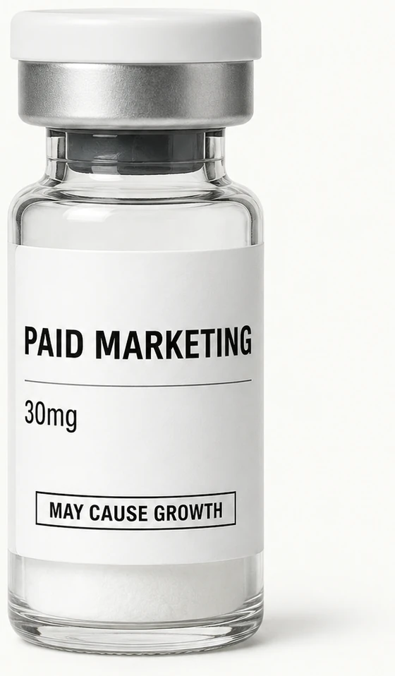 A glass vial with a white label reading Paid Marketing, 30mg, May Cause Growth.